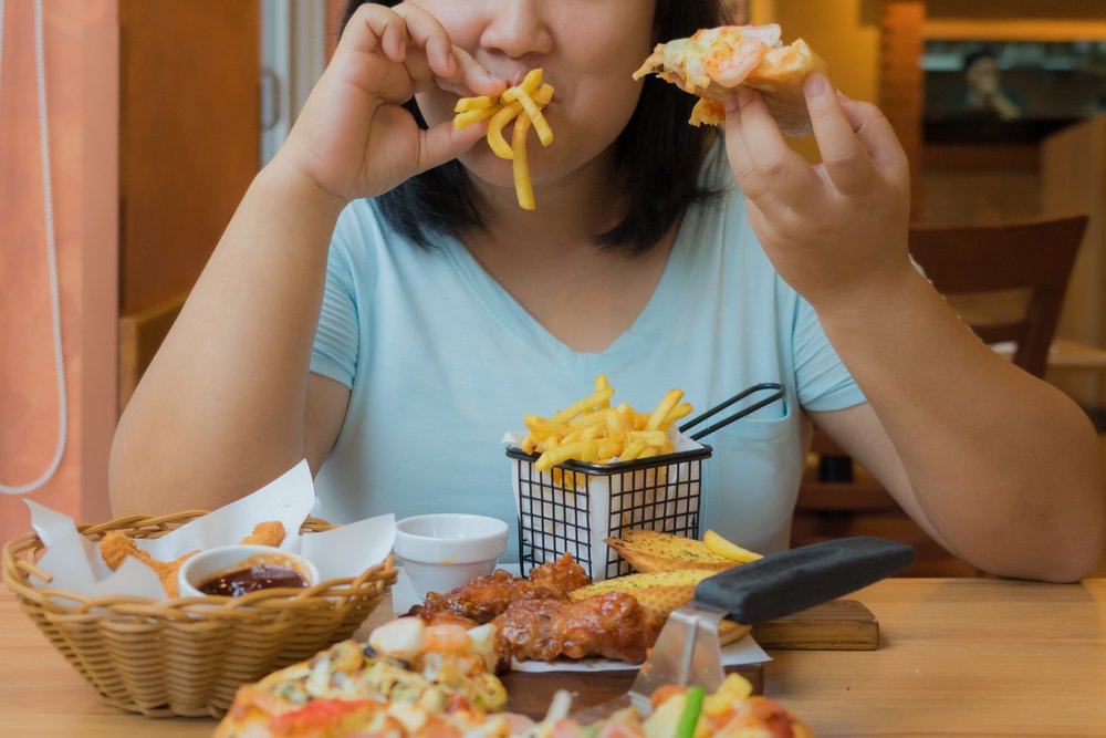 woman is eating french fries