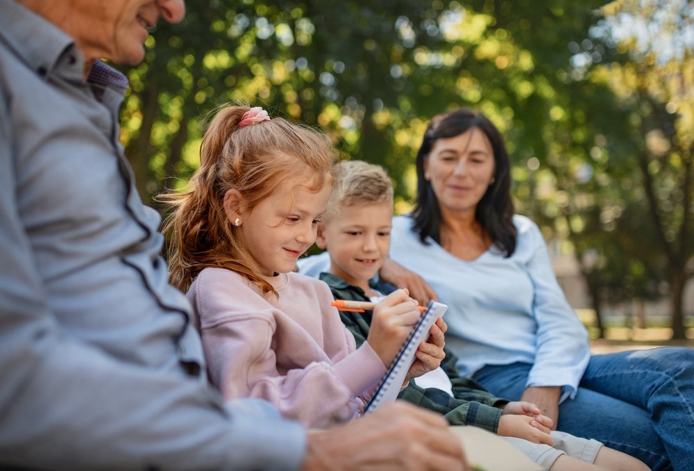 couple with grandchildren sitting on bench
